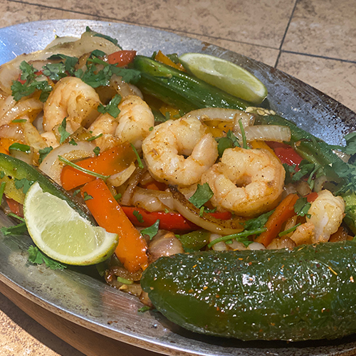 Home Sizzling shrimp fajitas at La Bonita's