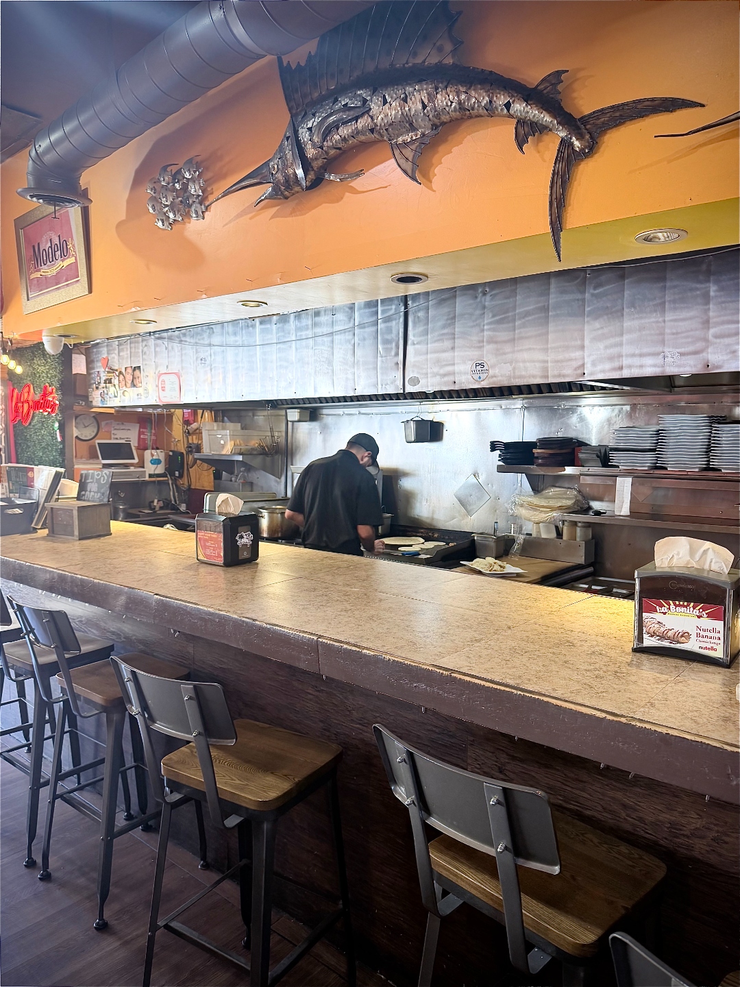 La Bonita's open kitchen with marlin sculpture and bar seating